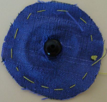 Cut the fabric circle's center a push snap's ball through it