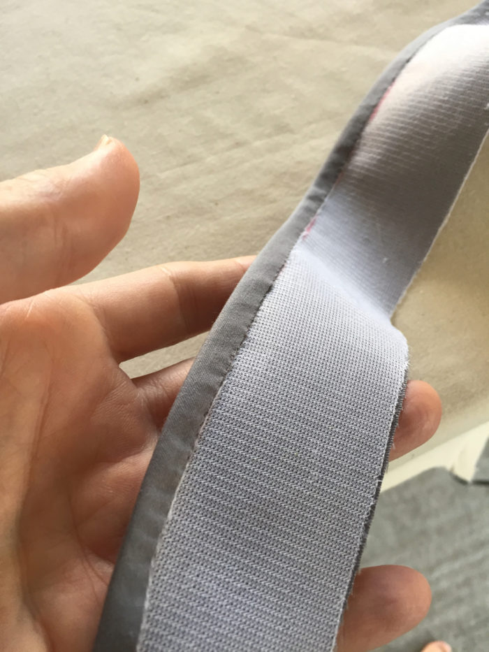 A 1/4-inch seam allowance is folded to the interfaced side of the collar stand and anchored by machine stitching.