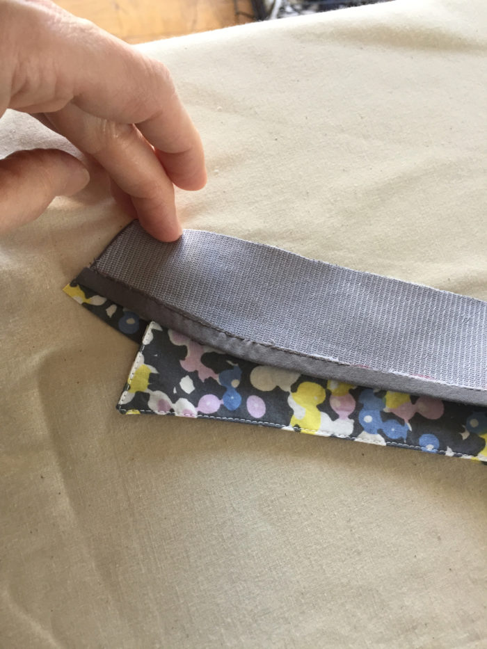 The gray inside collar stand is placed on top of the sewn outside stand/collar combo, with right sides together