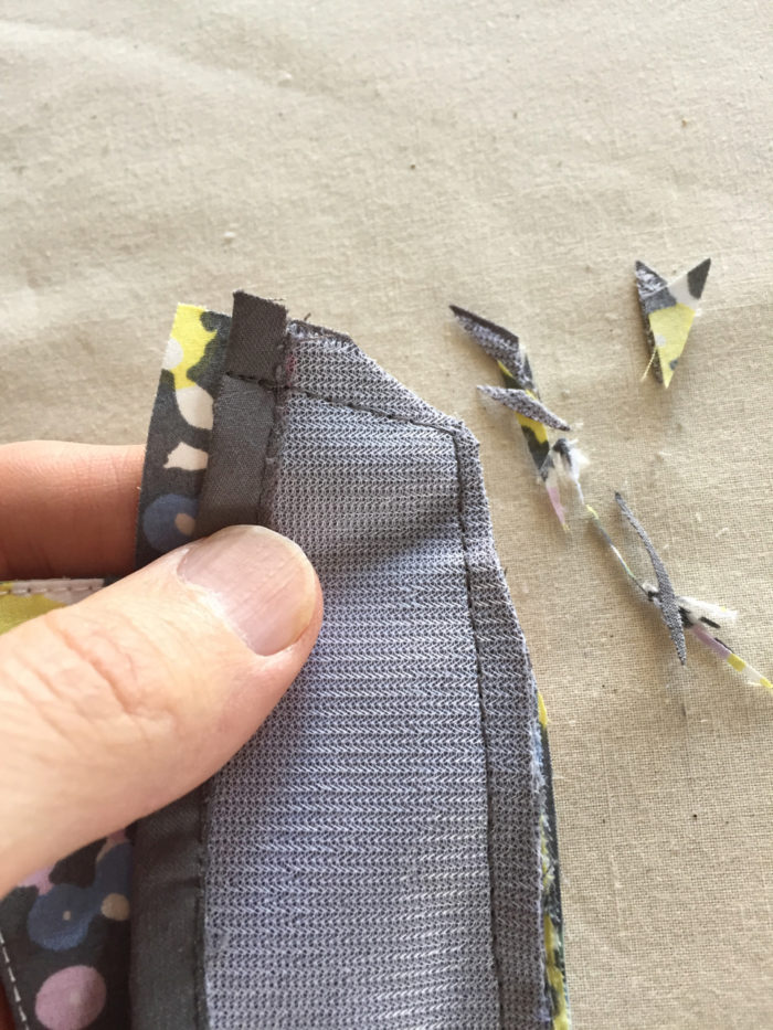 Corners of the sewn collar are trimmed from the wrong side