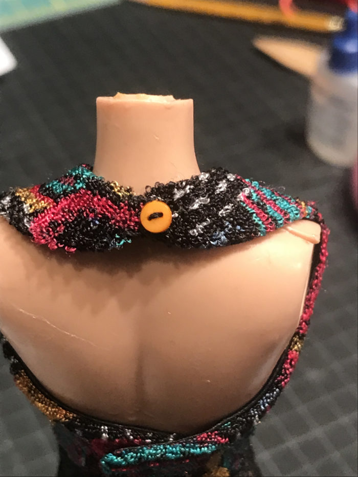 Sew a button and thread chain to the little blouse back neckline