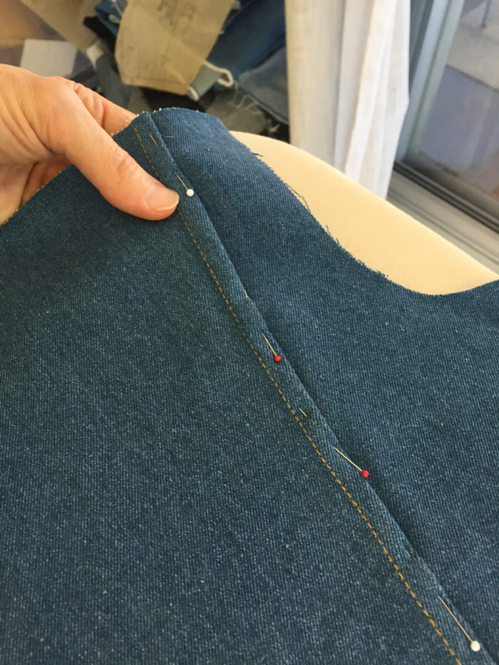 A flat-felled seam pinned and nearly completed on denim