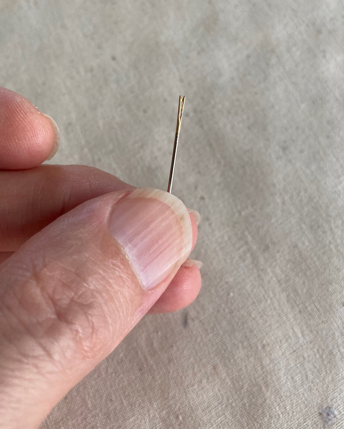 self-threading needle being held