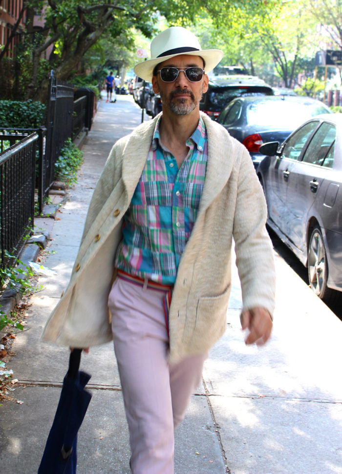 Peter Lappin wearing a shawl-collar sweater, madras shirt, and pink pants, all from his home-sewn wardrobe