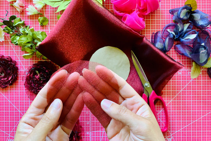 Sheer fabric cut into a circle, representing one fabric flower layer