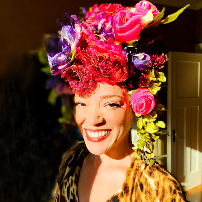 Marcy Harriell smiles as she wears a headpiece of flowers