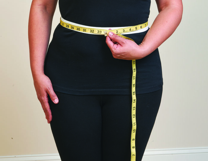 Fitting pants: Tape measure around a person's waist