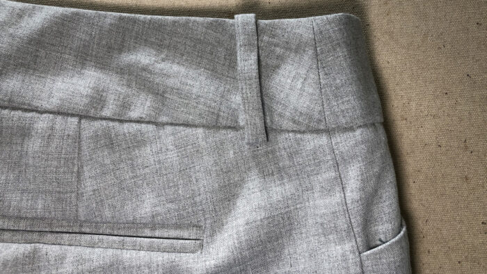 A pair of women's pants has waistband seams at the sides