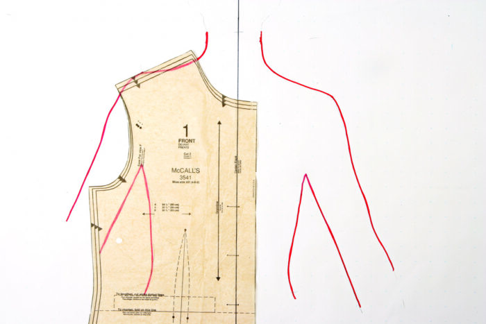 Tracing of upper body overlayed by a bodice pattern piece.