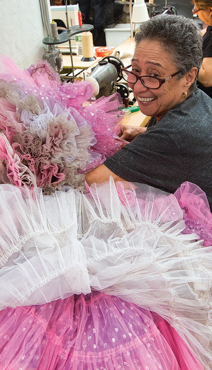 Woman sewing a gown for Rodgers & Hammerstein's Cinderella.