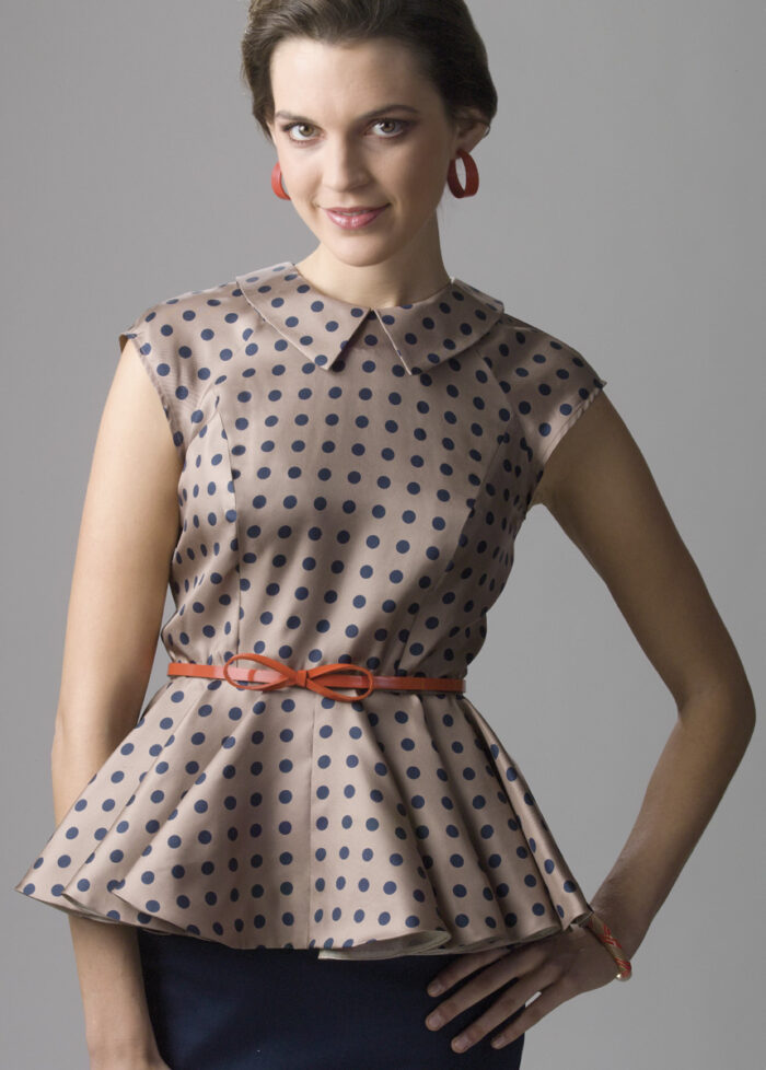 Model wearing a flouncy peplum design.