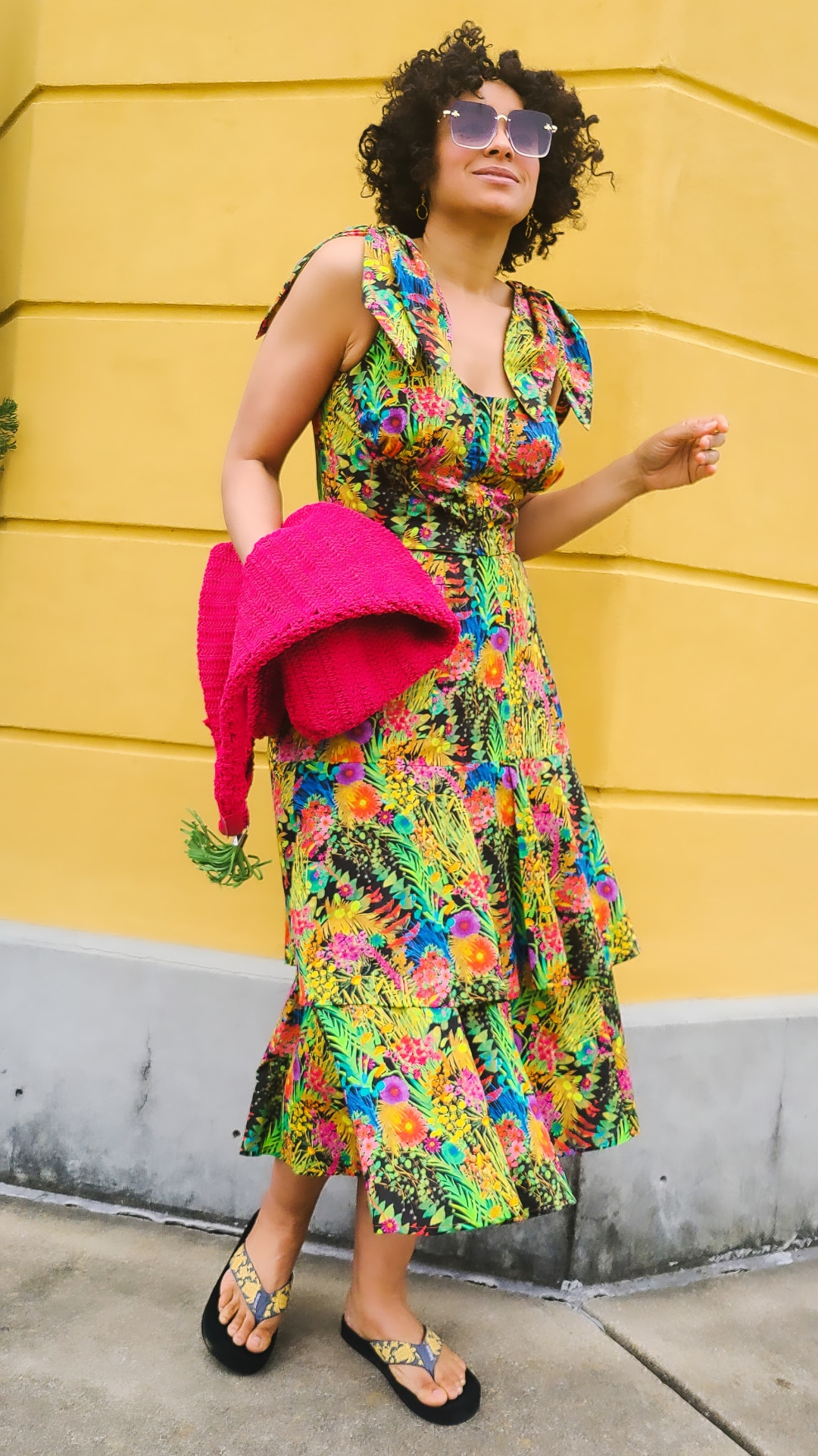 Marcia Spencer @keechiibstyle in a printed dress, with hot pink accessory