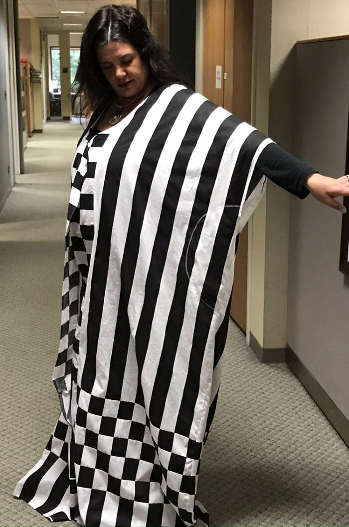 Becca Ryan wearing her striped caftan with checkerboard quilted hem