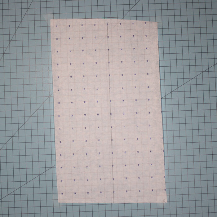 patternmaking paper lying on a gridded cutting mat