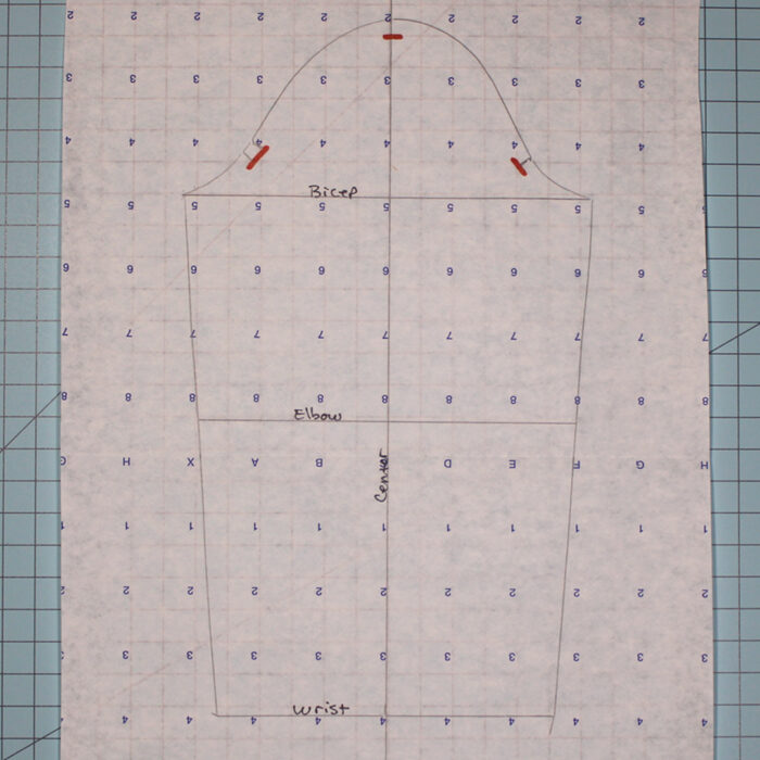 sleeve pattern with marked lines traced on patternmaking paper