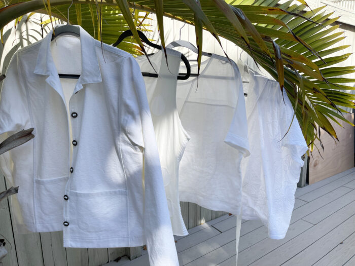 Becky Fulgoni white shirt challenge: Four finished tops on hangers in a tropical setting