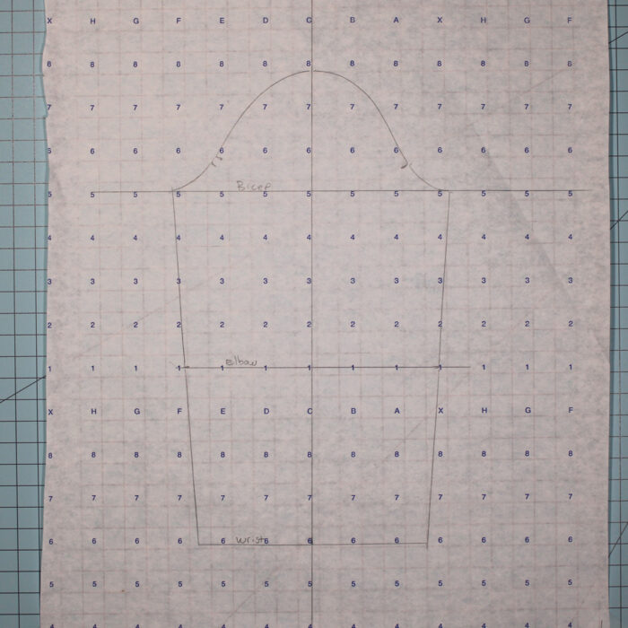 Sleeve sloper drawn in pencil on numbered pattern paper