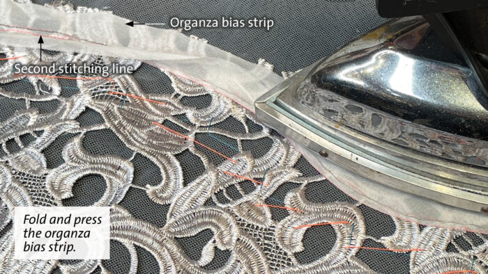 Stabilize lace edges: Press the organza bias strip