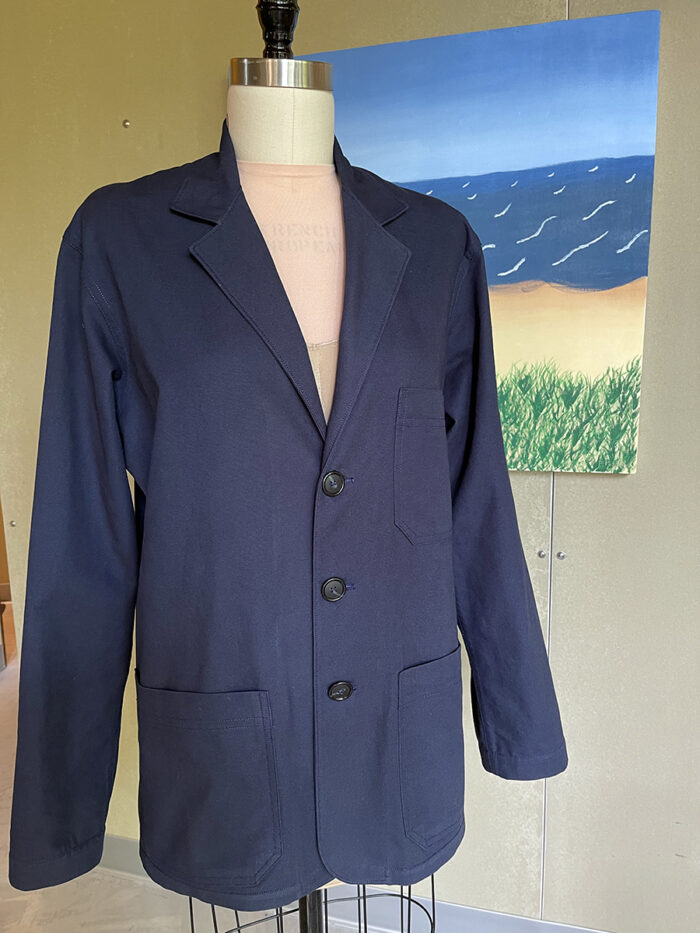 Men's shop coat on a dress form