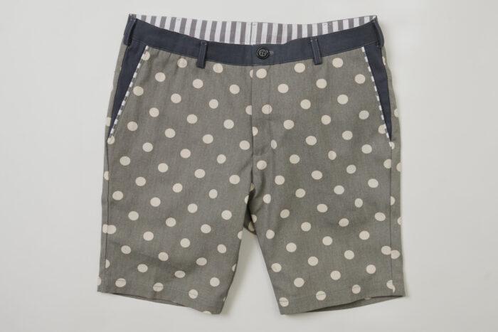 Men's light gray and white polka dot shorts with contrasting waistband and belt loops and striped waistband facing