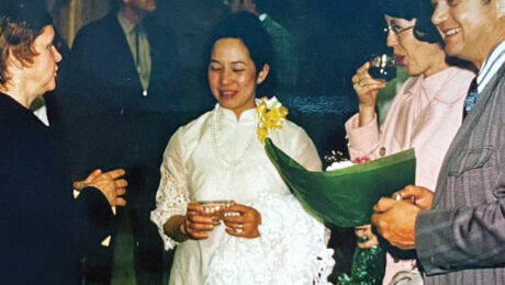 Woman wearing a white pina silk dress socializing at a recital